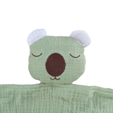 Green plush toy with a wombat face on a white background