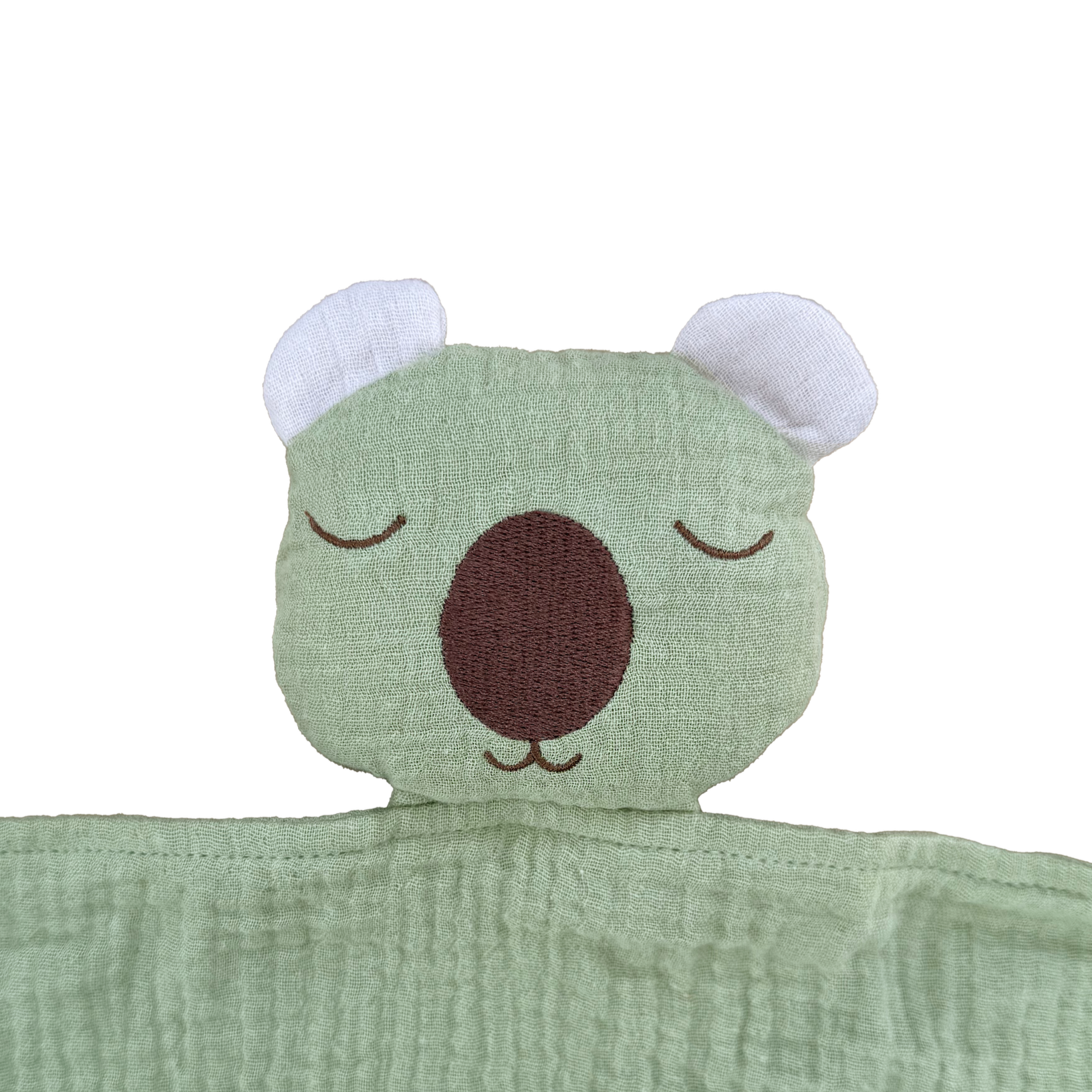 Green plush toy with a wombat face on a white background