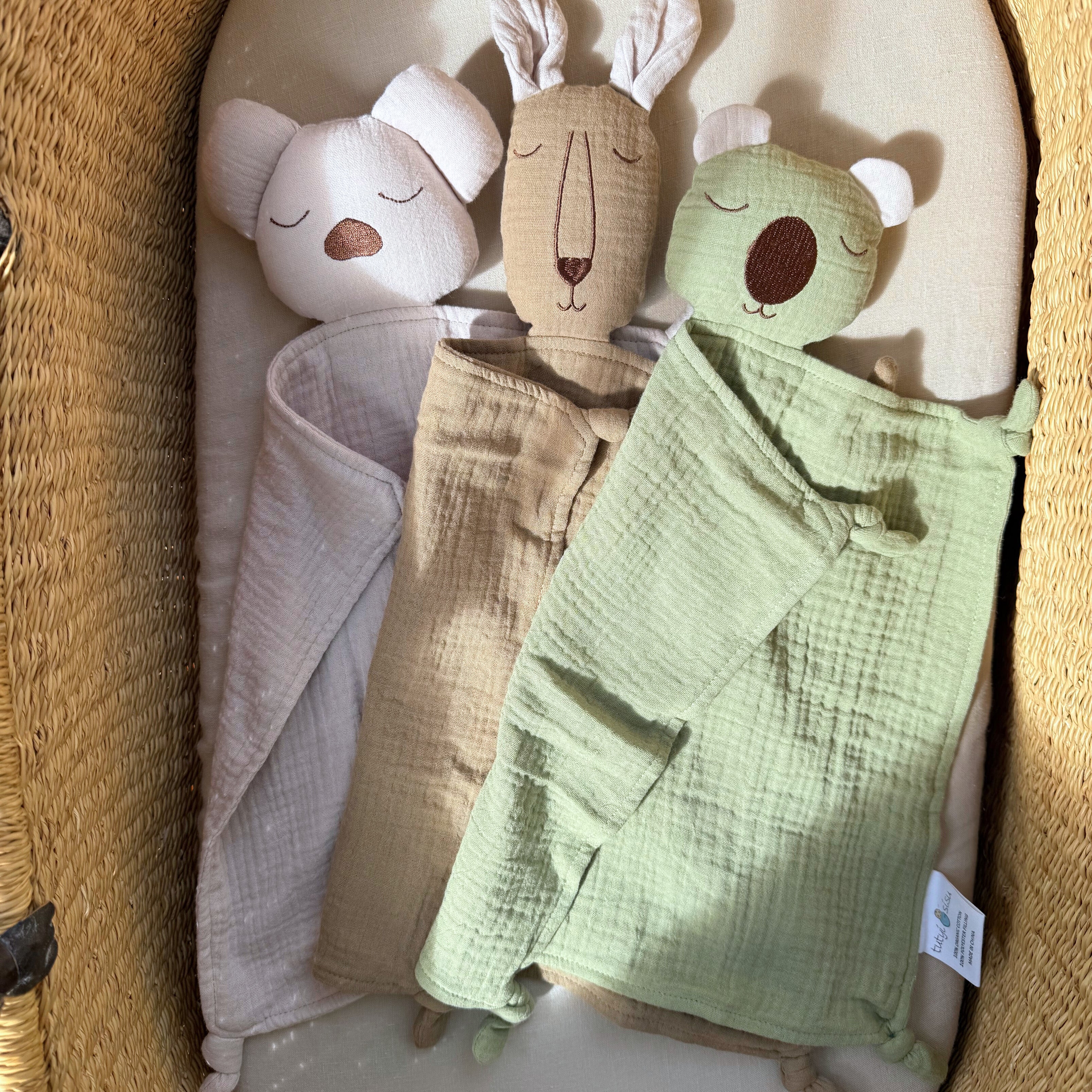Three baby & toddler comforters inside a wicker basket. Koala, joey & wombat. Australiana.